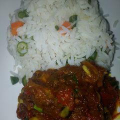 A picture of White rice with spring onion sauce.