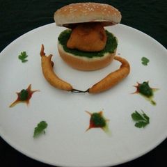 A picture of Vada pav with mirch vada.