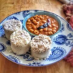 A picture of Puttu kadala (steamed rice cake and chickpea curry)Kerala Breakfast.