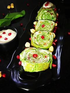 A picture of Spinach Crepe Rolls with Chickpea filling served with Banana sauce.