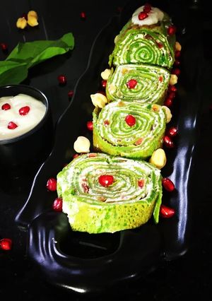 A picture of Spinach Crepe Rolls with Chickpea filling served with Banana sauce.