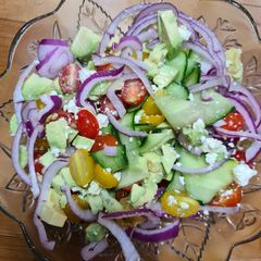 A picture of Cucumber, avocado, tomato and feta salad.