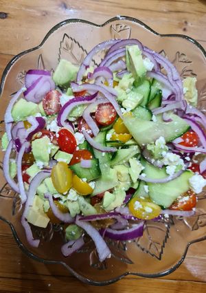 A picture of Cucumber, avocado, tomato and feta salad.