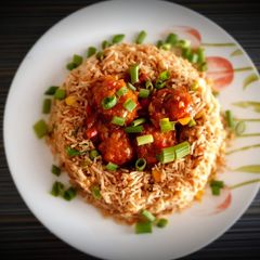 A picture of Manchurian and fried rice bowl.