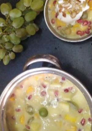 A picture of Fruit salad with ice cream.