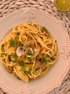 Una foto de Espaguetis con almejas, cilantro y lima