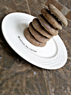 A picture of Chocolate cookies with leftover butter icing.