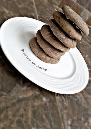 A picture of Chocolate cookies with leftover butter icing.