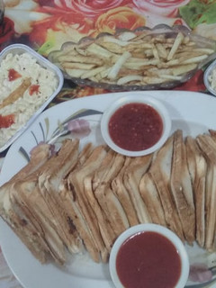 A picture of Chicken cheese sandwhich and Macroni salad.