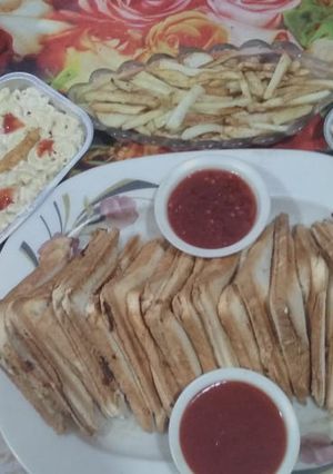 A picture of Chicken cheese sandwhich and Macroni salad.