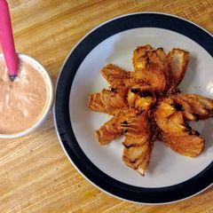 A picture of Baked blooming onion and dipping sauce.