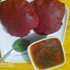 A picture of Beetroot poori and potato sabzi with spicy chutney.