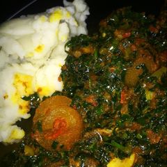 A picture of Pounded yam and vegetable soup.