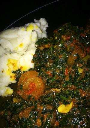 A picture of Pounded yam and vegetable soup.