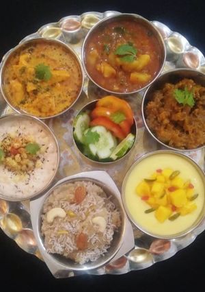 A picture of Indian Veg Thali (Aloo, Paneer, kaddu, Raita, Halwa, Shrikhand).