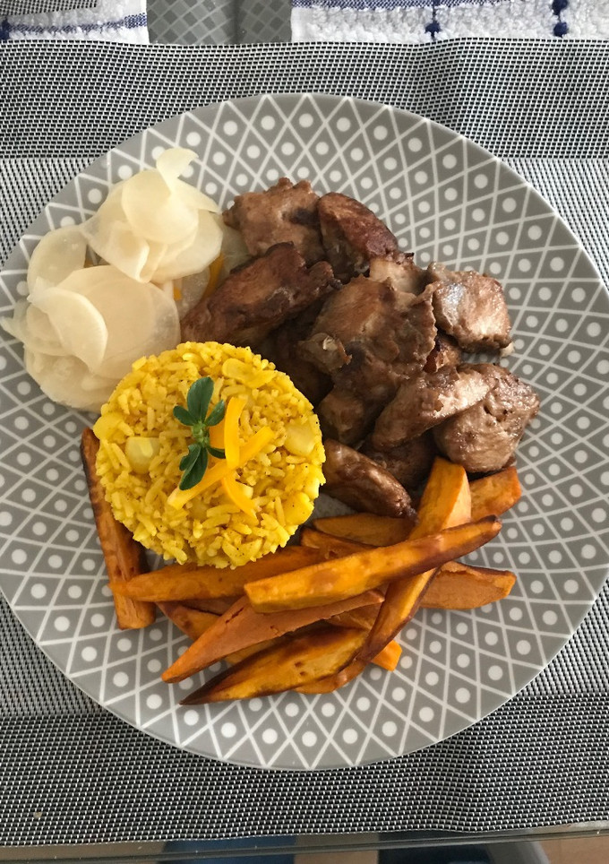 Una foto de Chicharrón de Pescado con bastones de Camote, arroz con choclo y encurtido de Nabo a lo Carmelita
