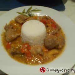 A picture of Amazing pork tigania with multi-colored peppers.