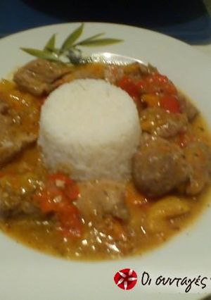 A picture of Amazing pork tigania with multi-colored peppers.