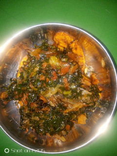 A picture of Fried plantain and water leaf stew.