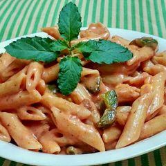 A picture of Red cheesy panne pasta.