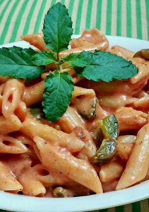 A picture of Red cheesy panne pasta.