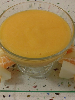 Una foto de Sorbete de piña y caqui con pinchitos de melón y mandarinas