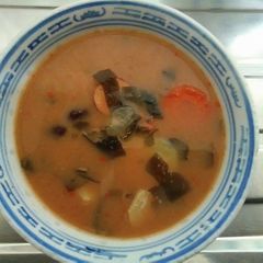 A picture of Japanese dashi miso soup with smoke sausage  twist of chilli yutaka  wakame sea weed.