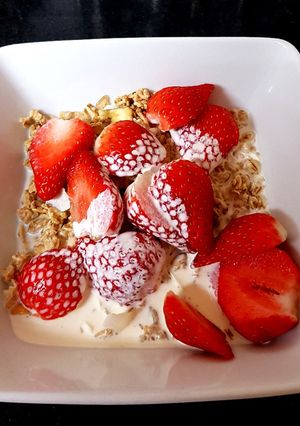 A picture of My Granola and fresh sliced strawberries +Cream ❣️.