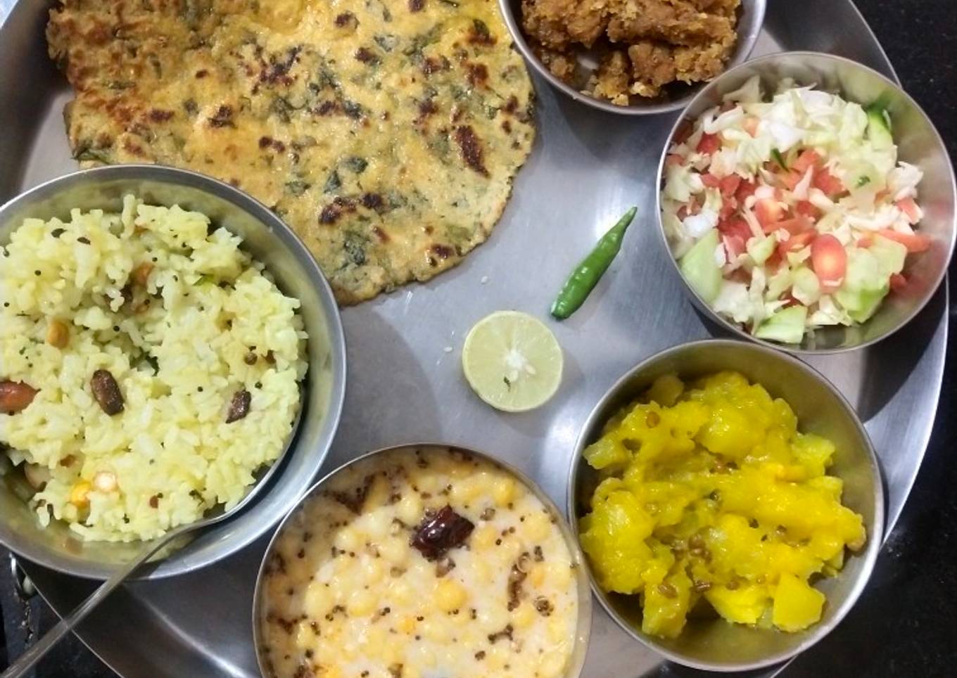 Yummy lunch platter makki roti, kaddu sabzi, fried rice, raita