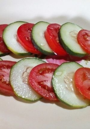 A picture of Tomato and cucumber salad.