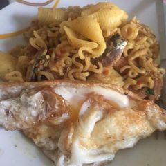 Sardine Noodles with cooked macaroni and fried egg A picture of Sardine Noodles with cooked macaroni and fried egg.