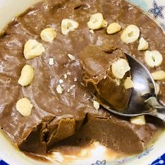 A picture of A bowl of chocolate fudge in microwave.