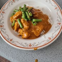 A picture of Quick butter chicken masala with mustard seed green beans and garlic rice.
