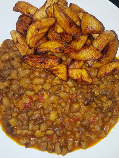 A picture of Spicy mashed beans with fried plantain.