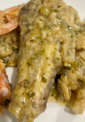 A picture of Monkfish Tails in Green Sauce with Clams and Shrimp.