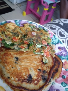 A picture of Blueberry banana pancakes with spinach omelet.