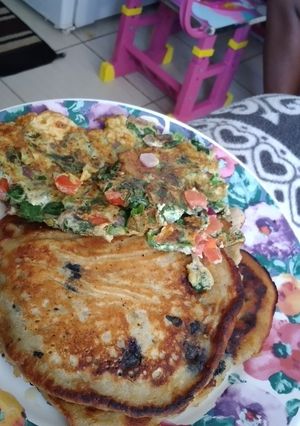 A picture of Blueberry banana pancakes with spinach omelet.