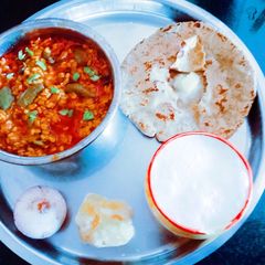 A picture of Healthy tasty fiber rich moong dal and turai sabji and millet flour roti.