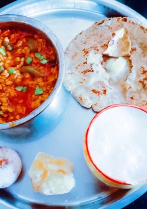 A picture of Healthy tasty fiber rich moong dal and turai sabji and millet flour roti.