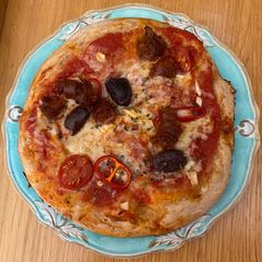A picture of Chorizo and olive pizza.