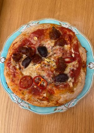 A picture of Chorizo and olive pizza.