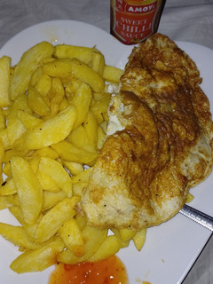 A picture of Chips,fried egg and sweet n chili sauce.