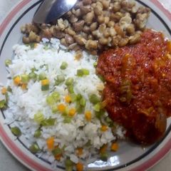 A picture of Rice ans beans with tomatoe sauce.