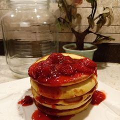 A picture of Pancakes with Starwberry Sauce.