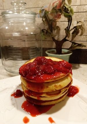 A picture of Pancakes with Starwberry Sauce.