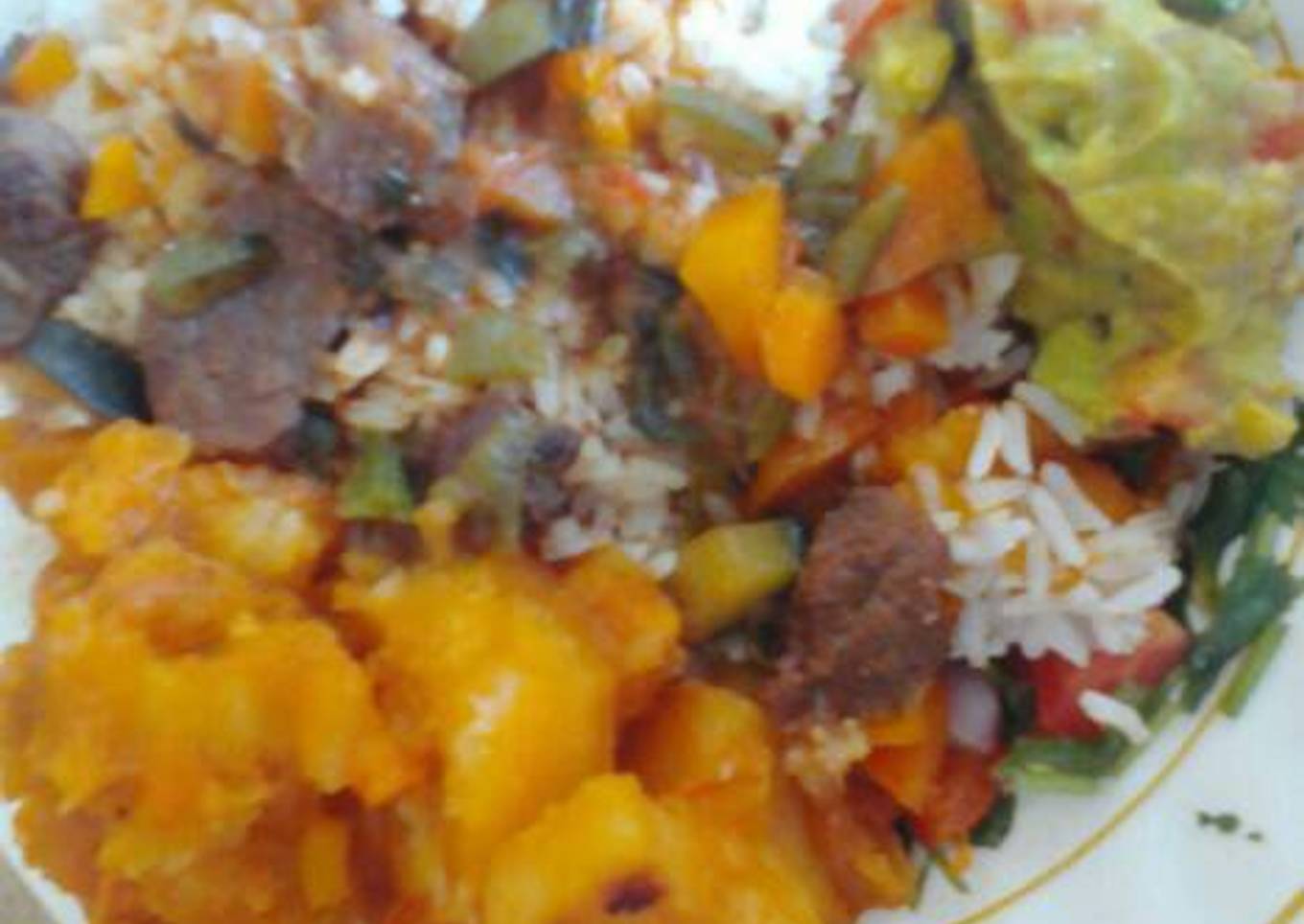 Beef stew and rice served with potatoes