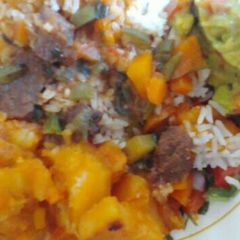 A picture of Beef stew and rice served with potatoes.