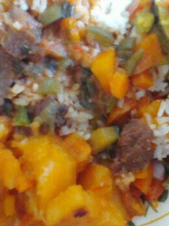 A picture of Beef stew and rice served with potatoes.