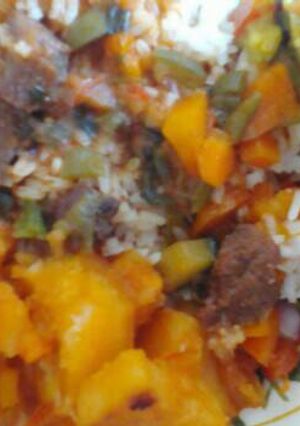 A picture of Beef stew and rice served with potatoes.