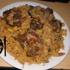 A picture of Jallof rice with Irish and meat.